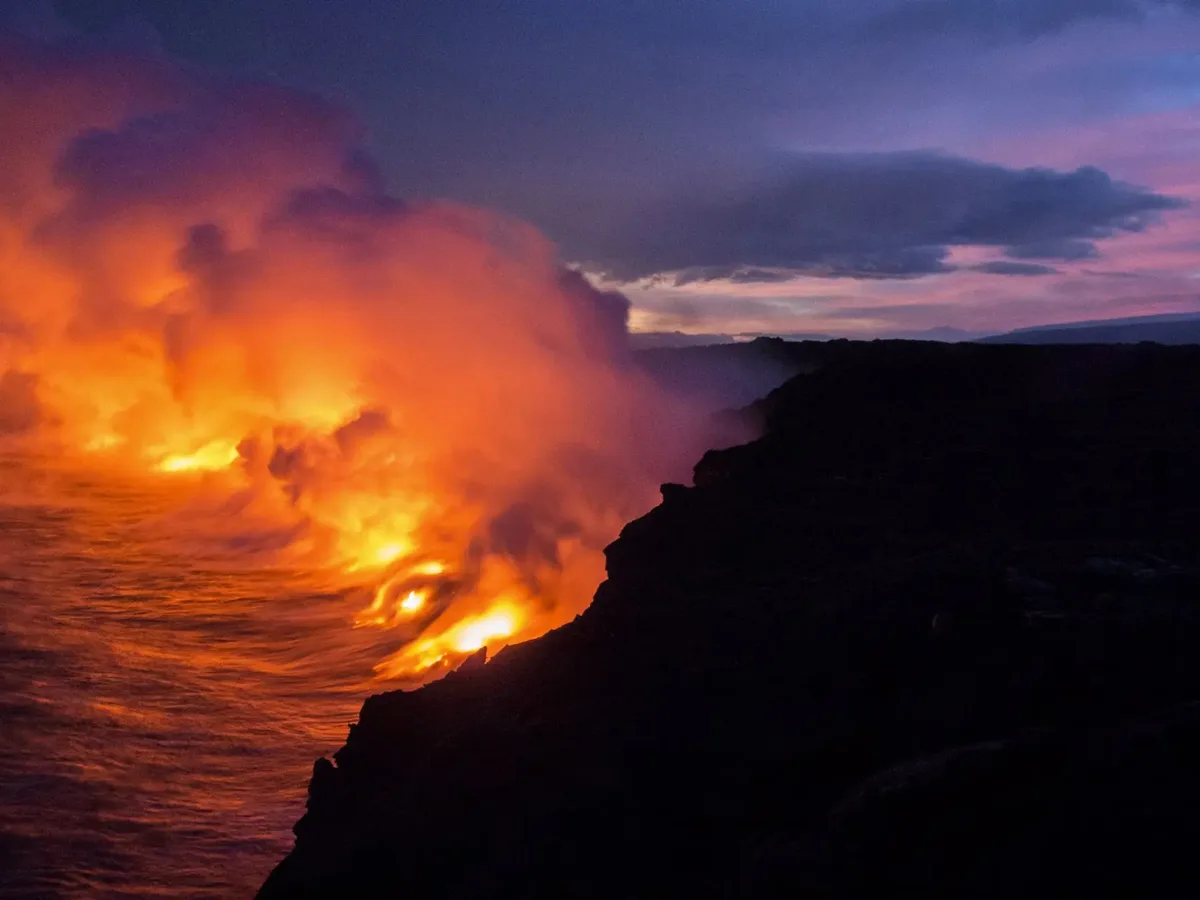 Kilauea lava meeting the ocean at dusk on the Big Island of Hawaii