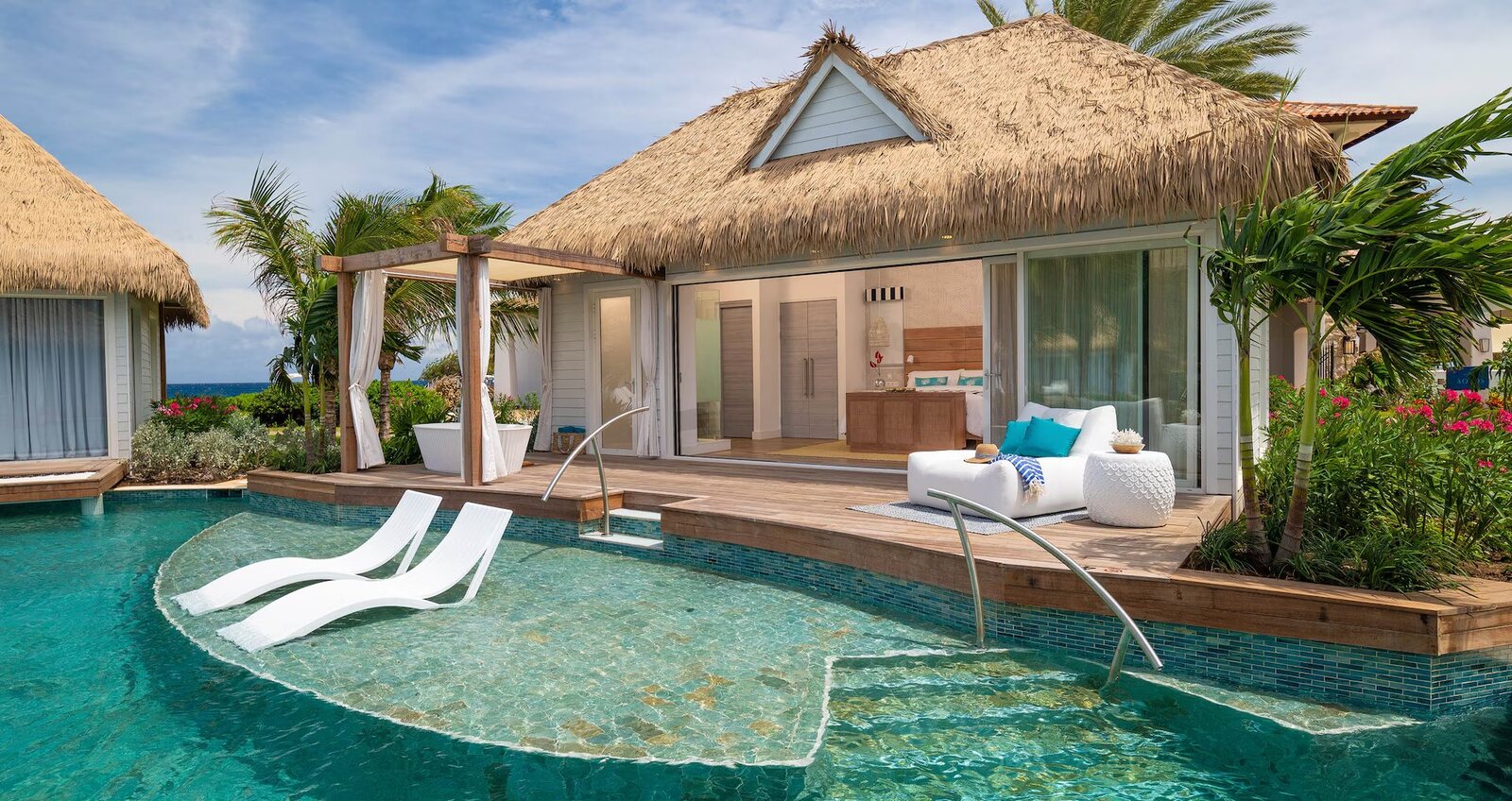 Thatched swim-up suite with in-pool loungers at a Sandals resort