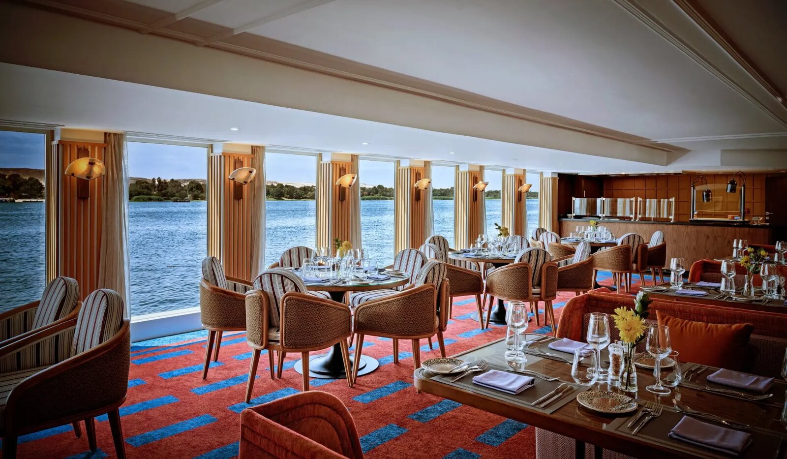 Dining room with floor-to-ceiling river views onboard an AmaWaterways ship on the Nile