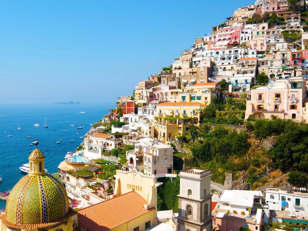 Positano on the Amalfi Coast, with the tiled dome of Santa Maria Assunta above the harbor
